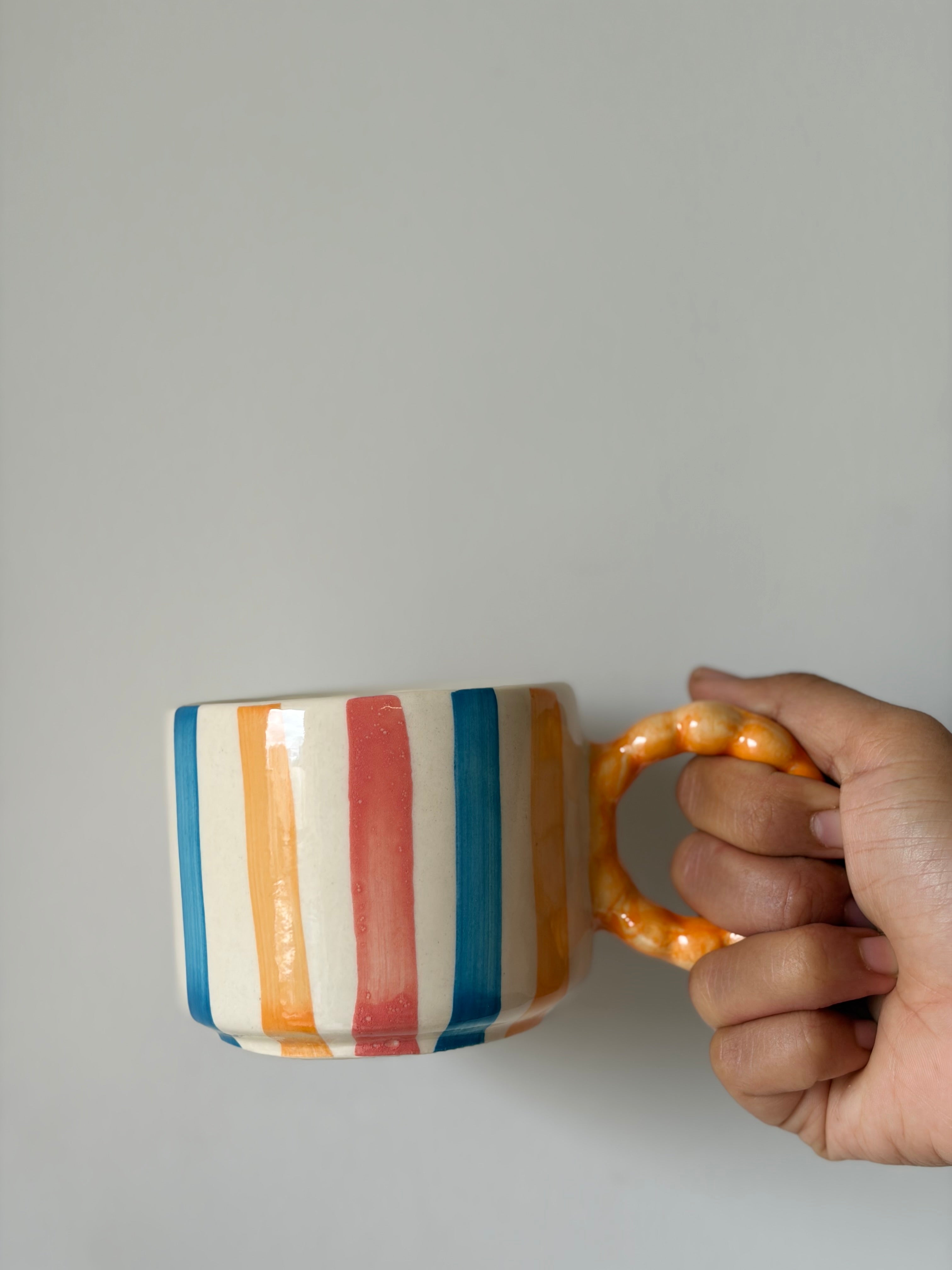 Colourful striped Orange handle mug