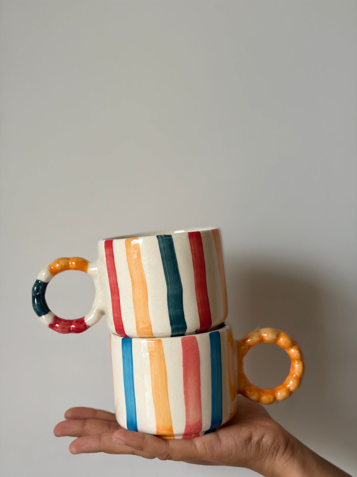 Colourful striped Orange handle mug